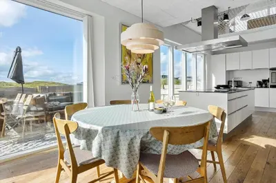 a kitchen and dining room with a table and chairs at 1053-Thisted-Kraenhavs-Sti-8 in Torsted