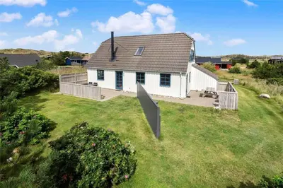 a white house on top of a green yard at 520-Snedsted-Sarasvej-10 in Snedsted