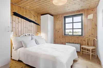a bedroom with a white bed and a window at 520-Snedsted-Sarasvej-10 in Snedsted