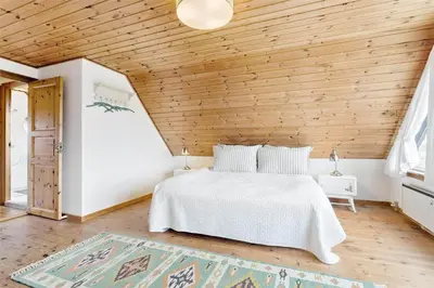 a bedroom with a white bed and a wooden ceiling at 520-Snedsted-Sarasvej-10 in Snedsted