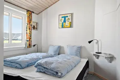 two beds in a room with a window at 451-Thisted-Nordsovej-20 in Thisted