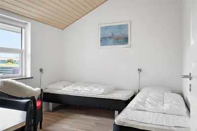 two beds in a room with a window at 409-Thisted-Flyndervej-8 in Thisted