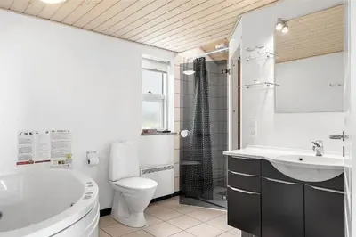 a bathroom with a tub and a toilet and a sink at 409-Thisted-Flyndervej-8 in Thisted