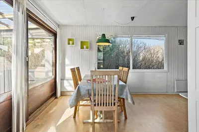 a dining room with a table and chairs and a window at 828-Thisted-Orredvej-13 in Thisted