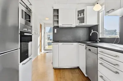 a kitchen with white cabinets and stainless steel appliances at 828-Thisted-Orredvej-13 in Thisted