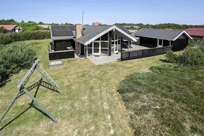 a house with a solar roof on top of a yard at 969-Thisted-Klitstien-50 in Torsted