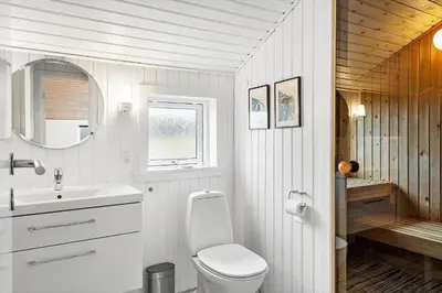 a white bathroom with a toilet and a sink at 904-Thisted-P-Bolesens-Vej-15 in Torsted