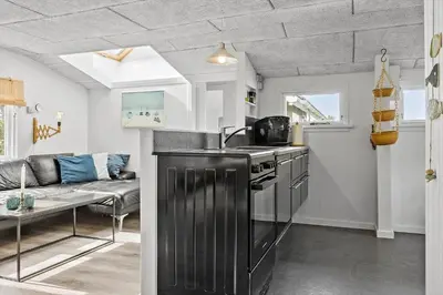 a kitchen with a stove and a couch in a room at 1308-Thisted-Tunvej-12 in Thisted