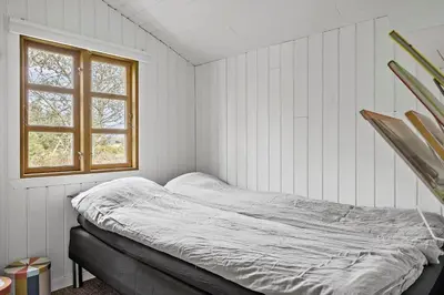 a bed in a white room with a window at 1308-Thisted-Tunvej-12 in Thisted