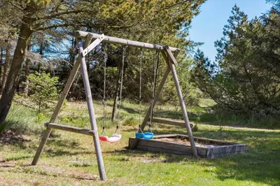 an empty swing set in a field with trees at 535-Thisted-Molgaardsvej-75 in Thisted