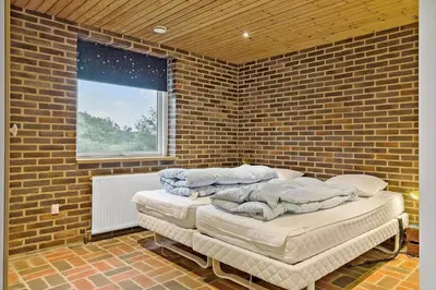 a brick room with two mattresses piled on top of each other at 991-Thisted-Liusborg-Sti-23 in Torsted