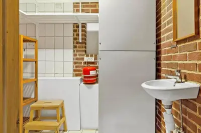 a bathroom with a white refrigerator and a sink at 991-Thisted-Liusborg-Sti-23 in Torsted