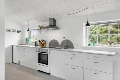 a white kitchen with white appliances and a window at 459-Snedsted-Istrupvej-48 in Snedsted