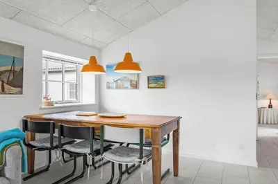 a dining room with a wooden table and chairs at 459-Snedsted-Istrupvej-48 in Snedsted