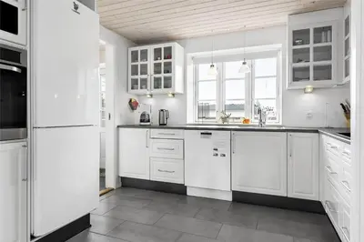 a white kitchen with white cabinets and white appliances at 222-Thisted-Nordsovej-57 in Thisted