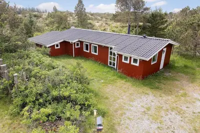 a red house in the middle of a field at 619-Thisted-Blabaervej-32 in Thisted