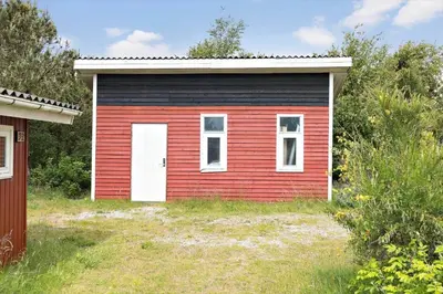 a small red and black house with a white door at 619-Thisted-Blabaervej-32 in Thisted