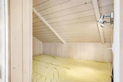 a small room with a bed in a wooden ceiling at 938-Thisted-Niels-Vognmands-Vej-8 in Torsted