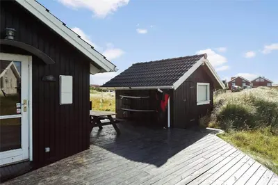 a wooden building with a picnic table next to it at 938-Thisted-Niels-Vognmands-Vej-8 in Torsted
