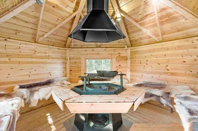 a stove in a log cabin with a wooden ceiling at 854-Thisted-Molgaardsvej-3 in Thisted