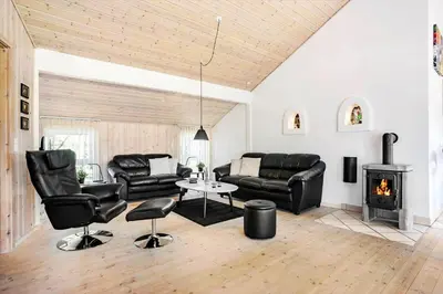 a living room with leather furniture and a fireplace at 854-Thisted-Molgaardsvej-3 in Thisted