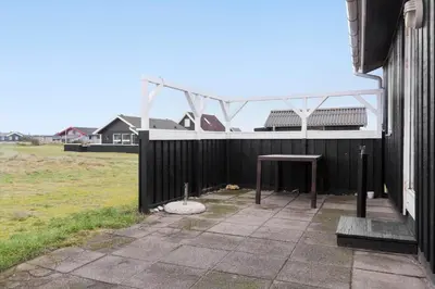 a patio with a table on the side of a building at 882-Thisted-Nordsovej-100 in Thisted