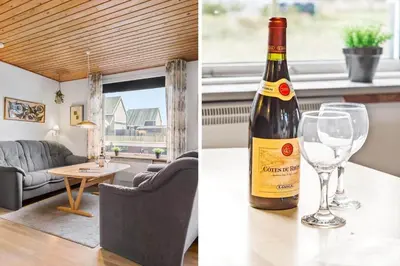 a bottle of wine sitting on a table with a wine glass at 882-Thisted-Nordsovej-100 in Thisted