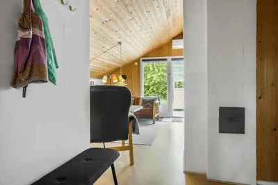 a living room with a chair and a table at 834-Thisted-Revlingvej-9 in Thisted