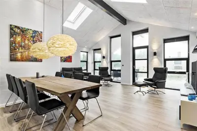 a dining room with a wooden table and chairs at 927-Thisted-Spanggardsvej-77 in Torsted
