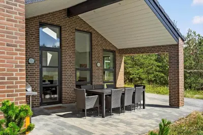 an outdoor patio with a table and chairs at 927-Thisted-Spanggardsvej-77 in Torsted