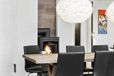 a dining room with a table and a fireplace at 927-Thisted-Spanggardsvej-77 in Torsted