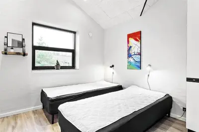 two beds in a room with white walls and a window at 927-Thisted-Spanggardsvej-77 in Torsted