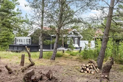 a yard with trees and a bench in front of a house at 997-Thisted-Lyngstien-15-B in Torsted