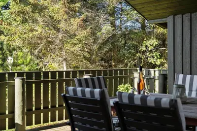 a wooden table and chairs on a deck at 646-Thisted-Bredkaervej-43 in Thisted