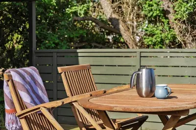 a wooden table and chairs with a tea kettle on it at 646-Thisted-Bredkaervej-43 in Thisted