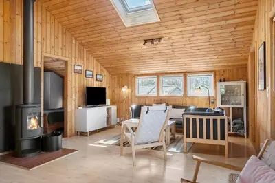 a living room with a table and a fireplace at 646-Thisted-Bredkaervej-43 in Thisted
