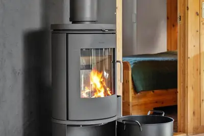 a stove with a fire in it in a room at 646-Thisted-Bredkaervej-43 in Thisted