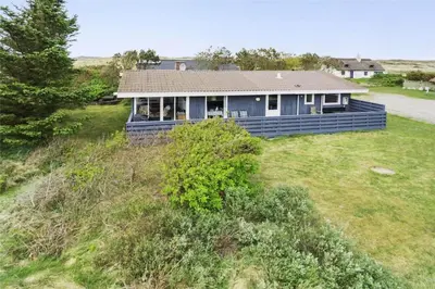 a blue house on top of a grassy hill at 215-Thisted-Tunvej-29 in Thisted