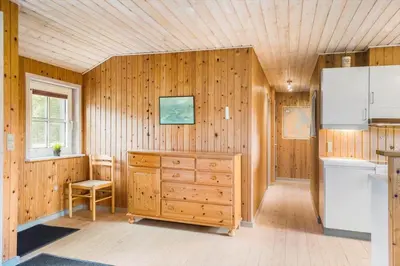 a kitchen with wooden walls and a dresser in a room at 861-Thisted-Havbovej-41 in Thisted