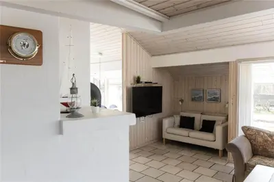 a living room with a tv and a couch and a chair at 951-Thisted-Bavnbak-39 in Torsted