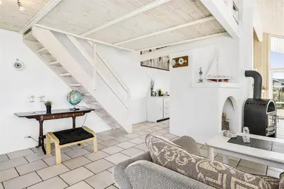 a living room with a couch and a stove at 951-Thisted-Bavnbak-39 in Torsted