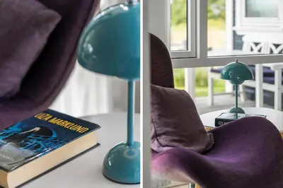 a lamp sitting on a table next to a book and a chair at 866-Thisted-Klemsvej-35 in Thisted