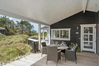 a patio with a table and chairs on a deck at 866-Thisted-Klemsvej-35 in Thisted
