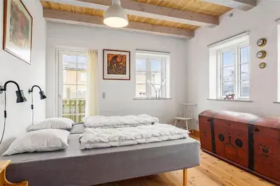 a bedroom with a large bed in a room with windows at 125-Thisted-Fiskervej-7 in Thisted