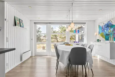 a white dining room with a table and chairs at 744-Thisted-Orredvej-26 in Thisted