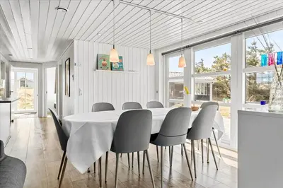 a white dining room with a table and chairs at 744-Thisted-Orredvej-26 in Thisted