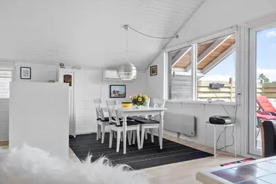 a white dining room with a table and a window at 447-Thisted-Kuttervej-13 in Thisted