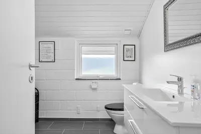a white bathroom with a toilet and a sink at 447-Thisted-Kuttervej-13 in Thisted