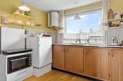 a kitchen with a white refrigerator and a sink at 240-Thisted-Hummervej-10 in Thisted