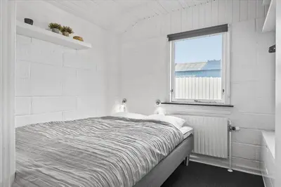 a white bedroom with a bed and a window at 670-Thisted-Krebsvej-4 in Thisted